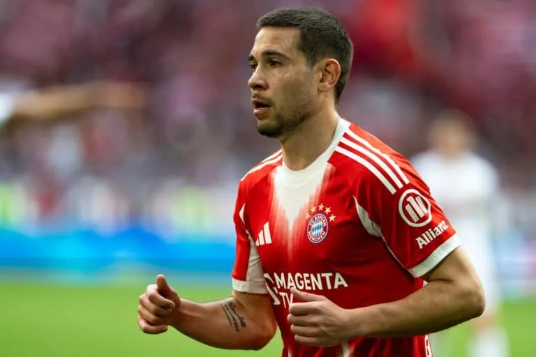 Footballer in a red Bayern Munich jersey running during a match.