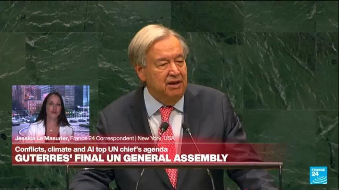 UN official speaking at a podium against a green marble backdrop during a televised broadcast