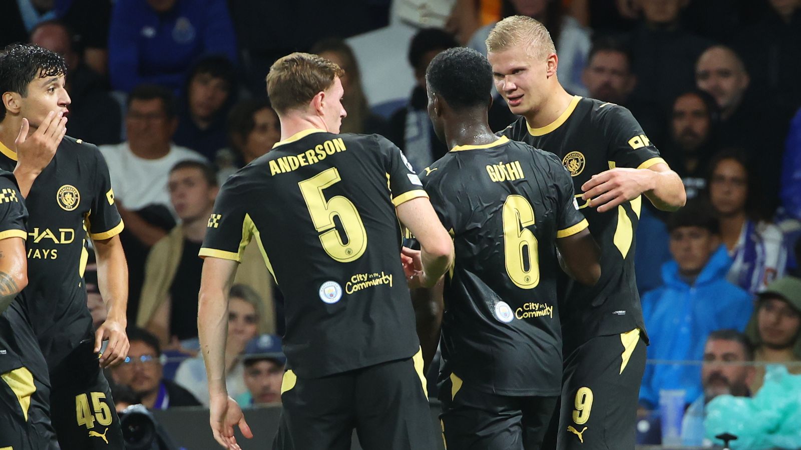 Manchester City players gather and celebrate during a football match