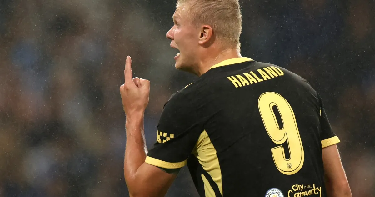 Footballer in Manchester City’s Haaland number nine shirt raises one finger during a match