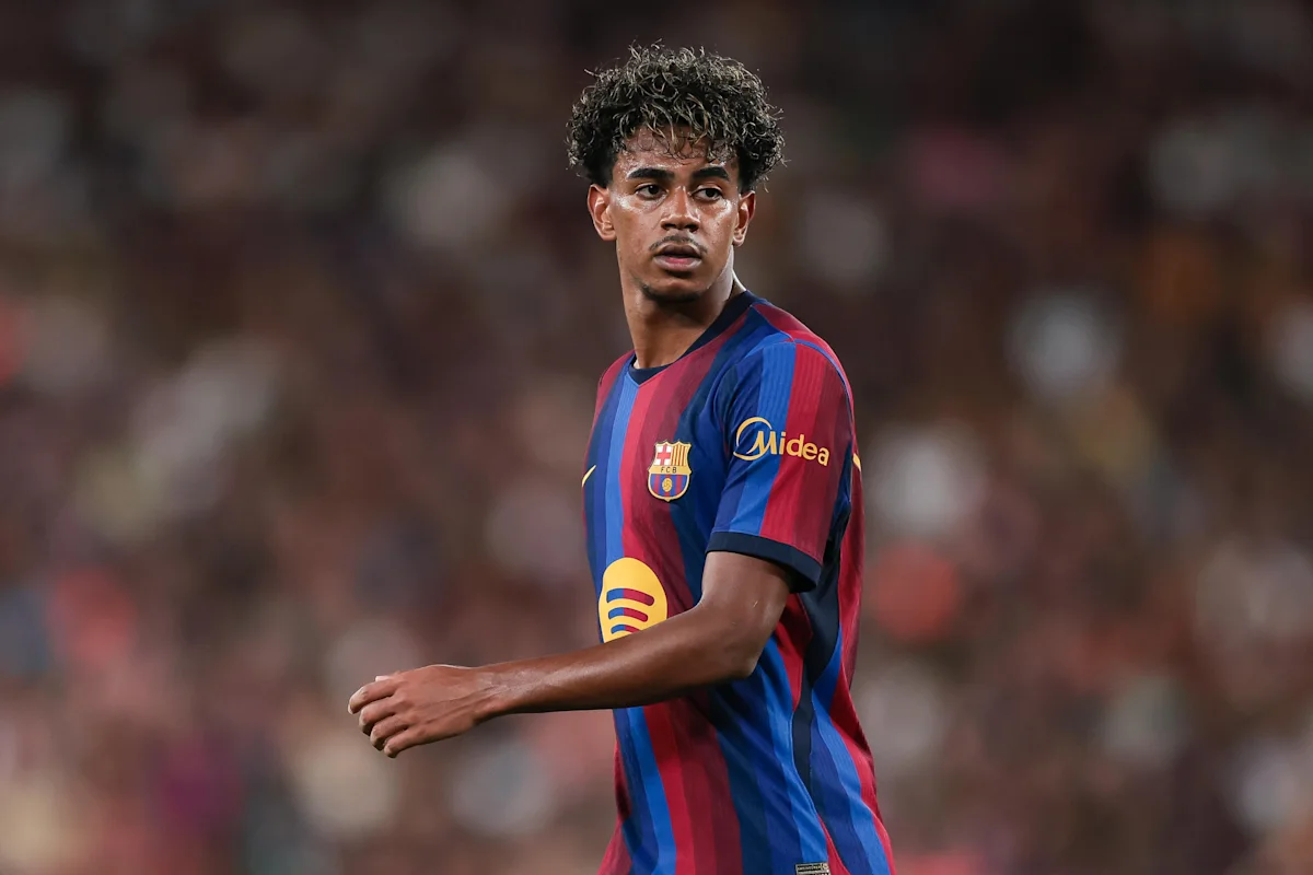 Young footballer in Barcelona colors standing on the pitch during a match
