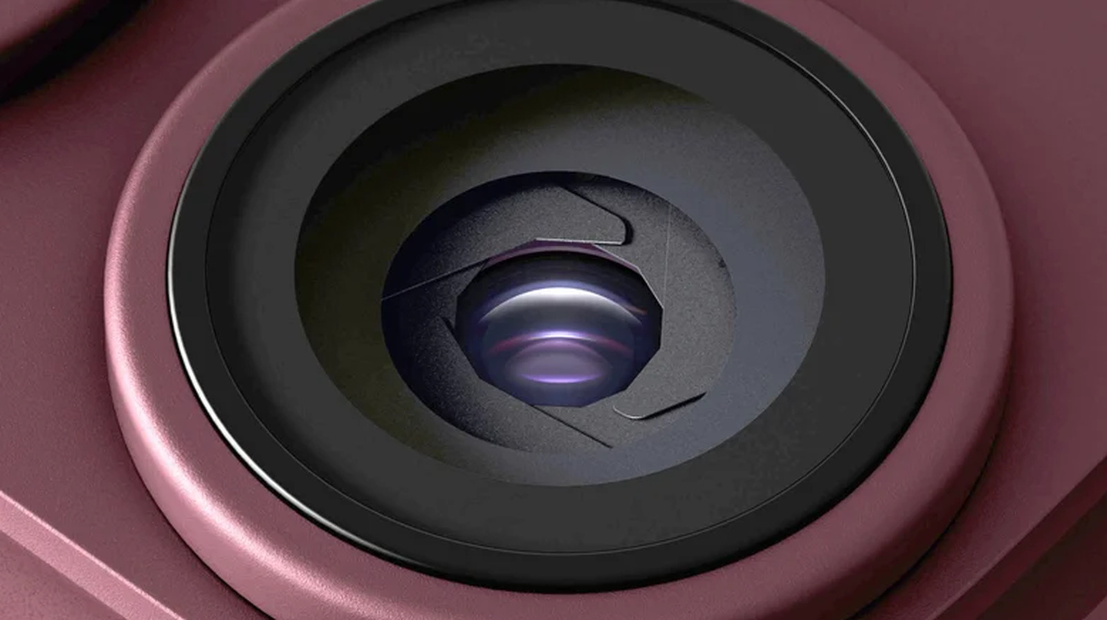 Close-up of a smartphone camera lens with purple reflections in a pink housing