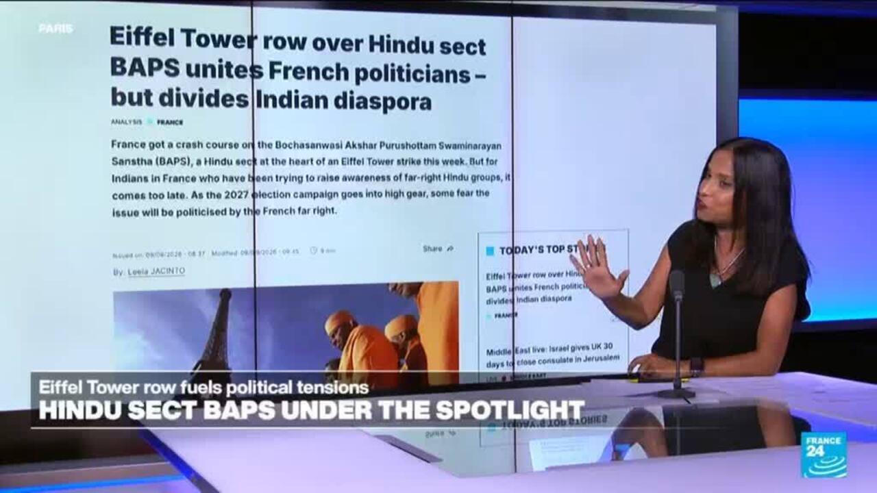 Television presenter gestures beside a screen displaying a news article about BAPS and Eiffel Tower controversy.