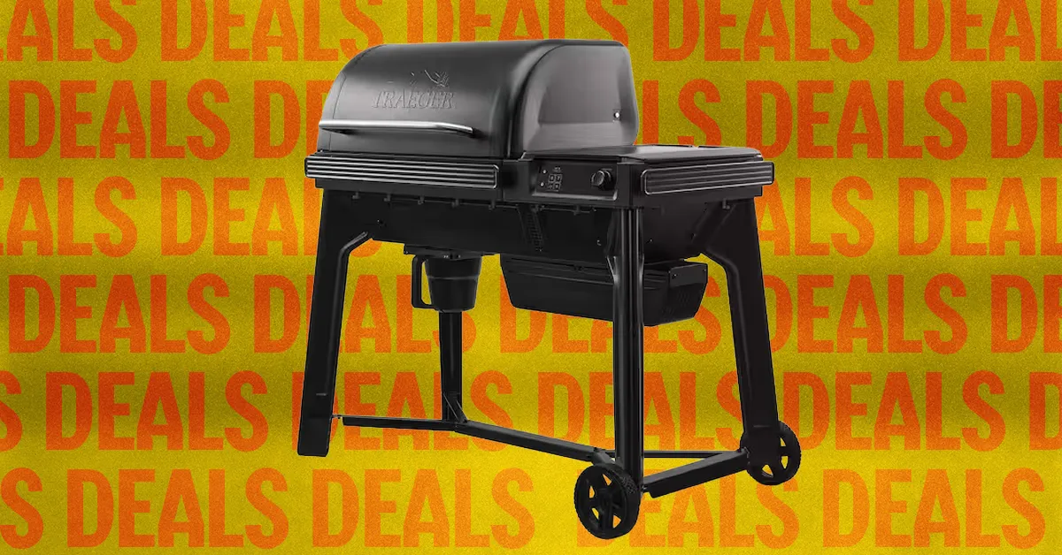 Black two-burner gas grill with side shelves and wheels against a repeating orange deals background.