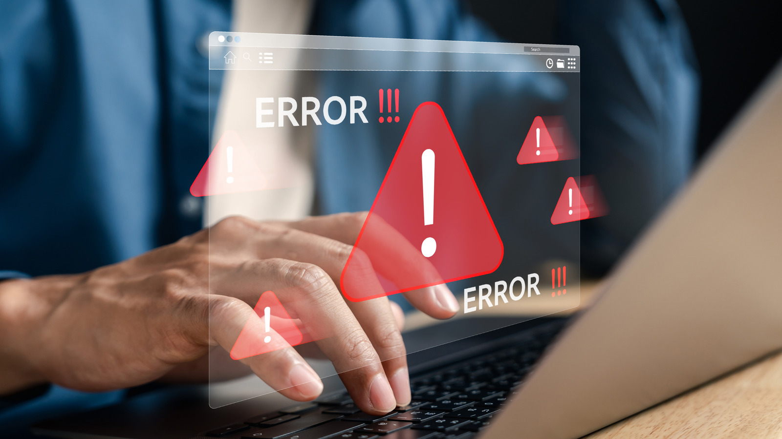 Hand using a laptop beneath a translucent error window with red warning symbols