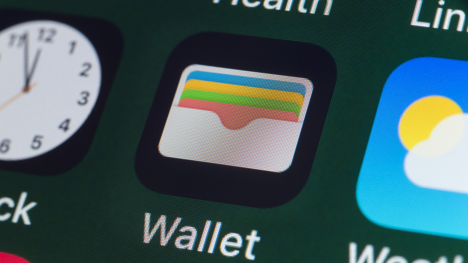 Close-up of Apple Wallet icon displayed among app icons on a digital screen