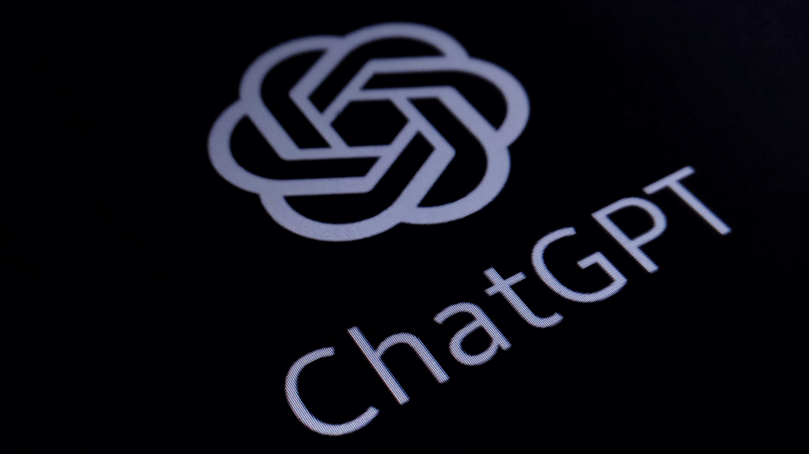 OpenAI logo and ChatGPT text displayed diagonally on a dark screen
