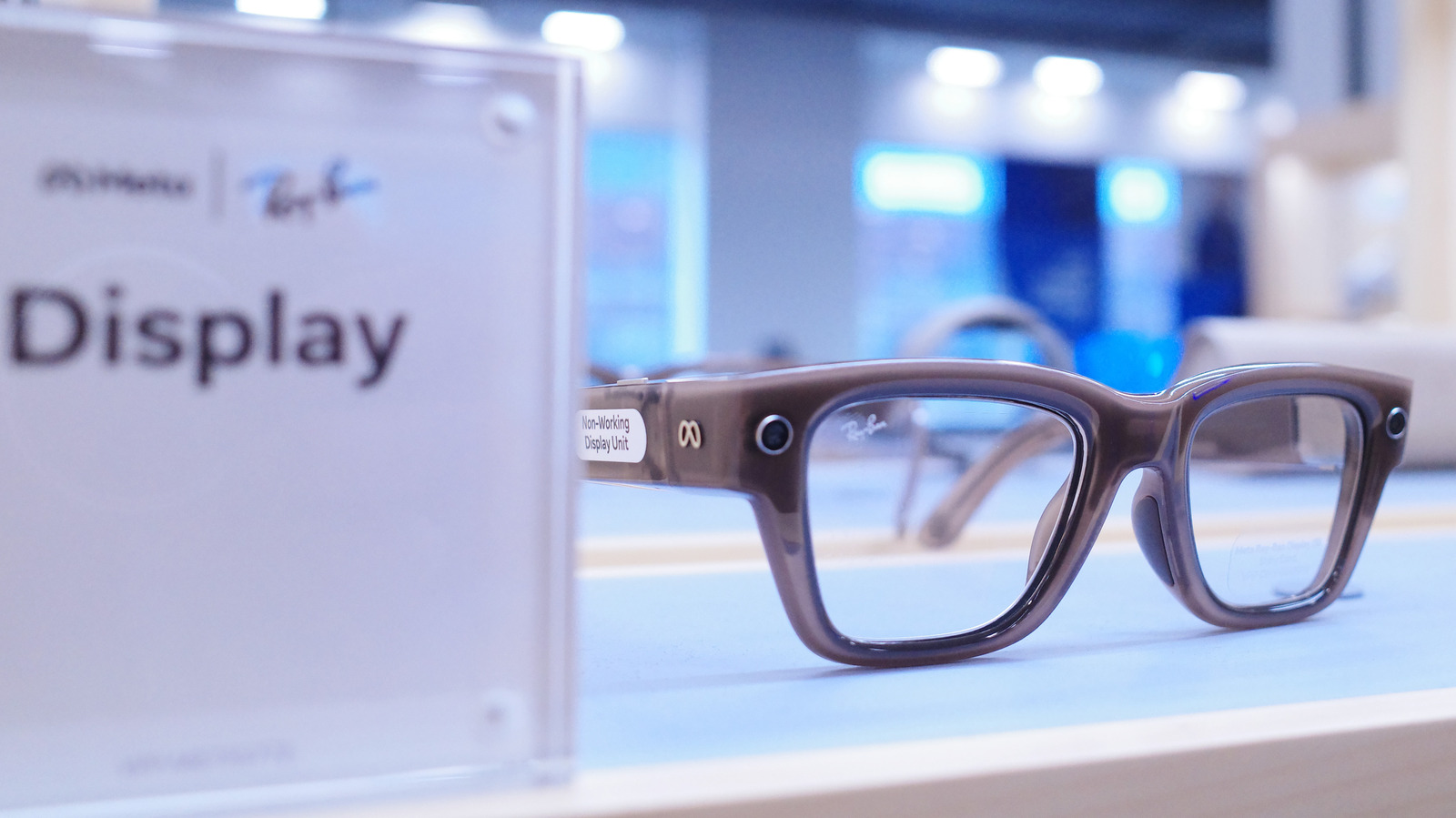 Meta display glasses resting on a counter beside a sign labeled Display