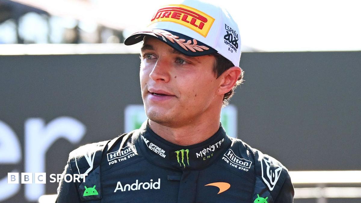 Formula One driver in McLaren racing suit and Pirelli cap during a post-race interview