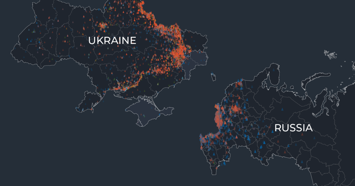 Dark map labeled Ukraine and Russia, covered with dense orange, blue and red triangular markers.