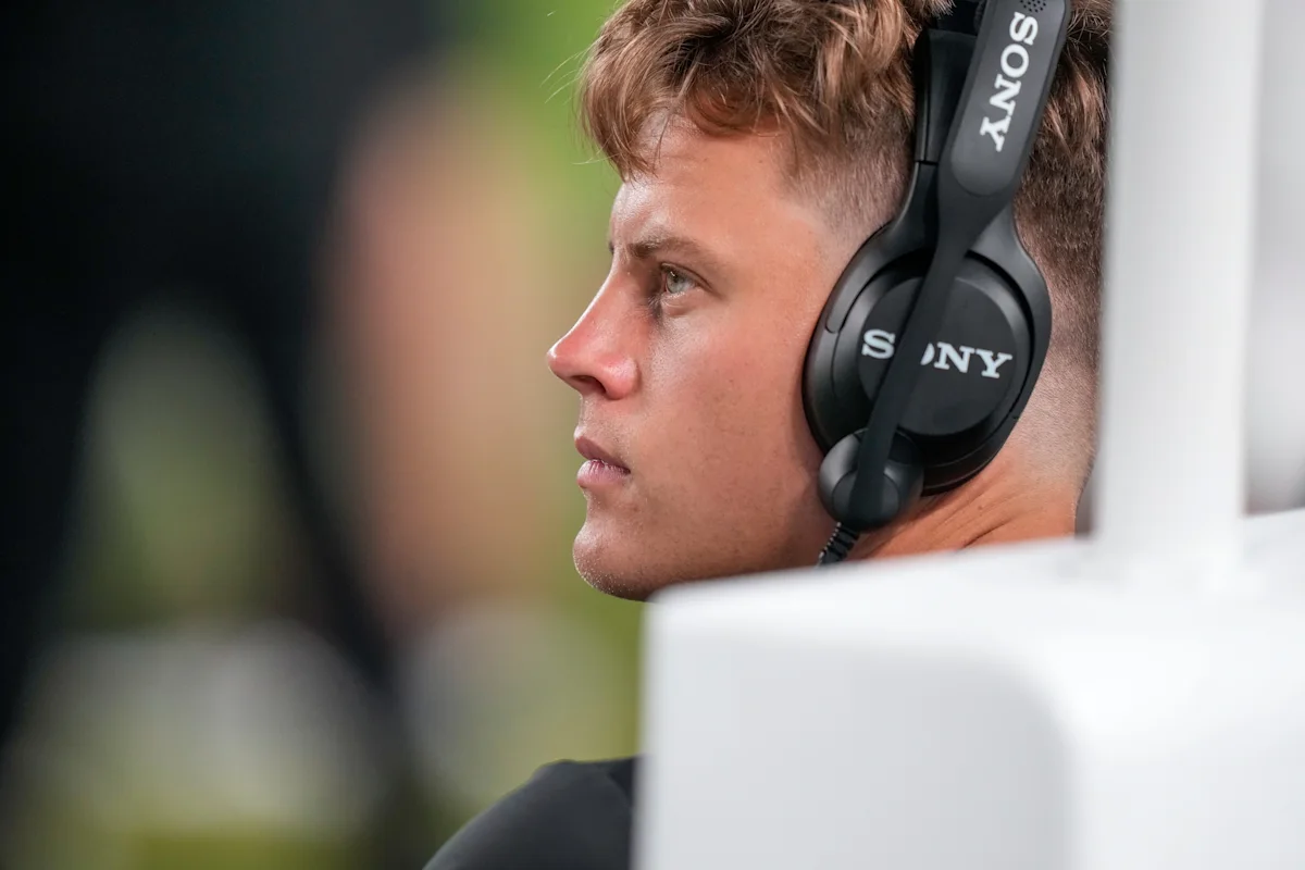 Profile of a football player wearing a Sony headset and looking toward the field.