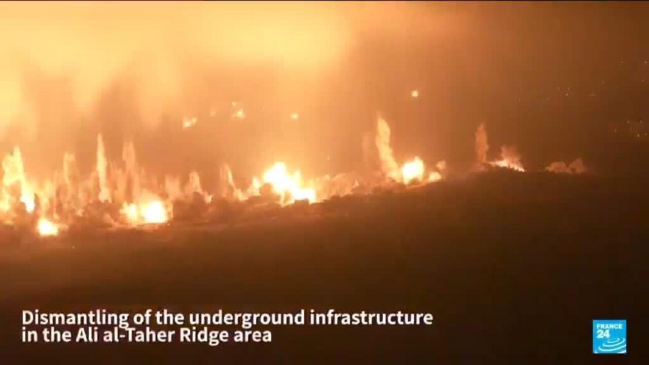 Nighttime explosions and flames erupt across dark terrain, with a France 24 caption overlay.