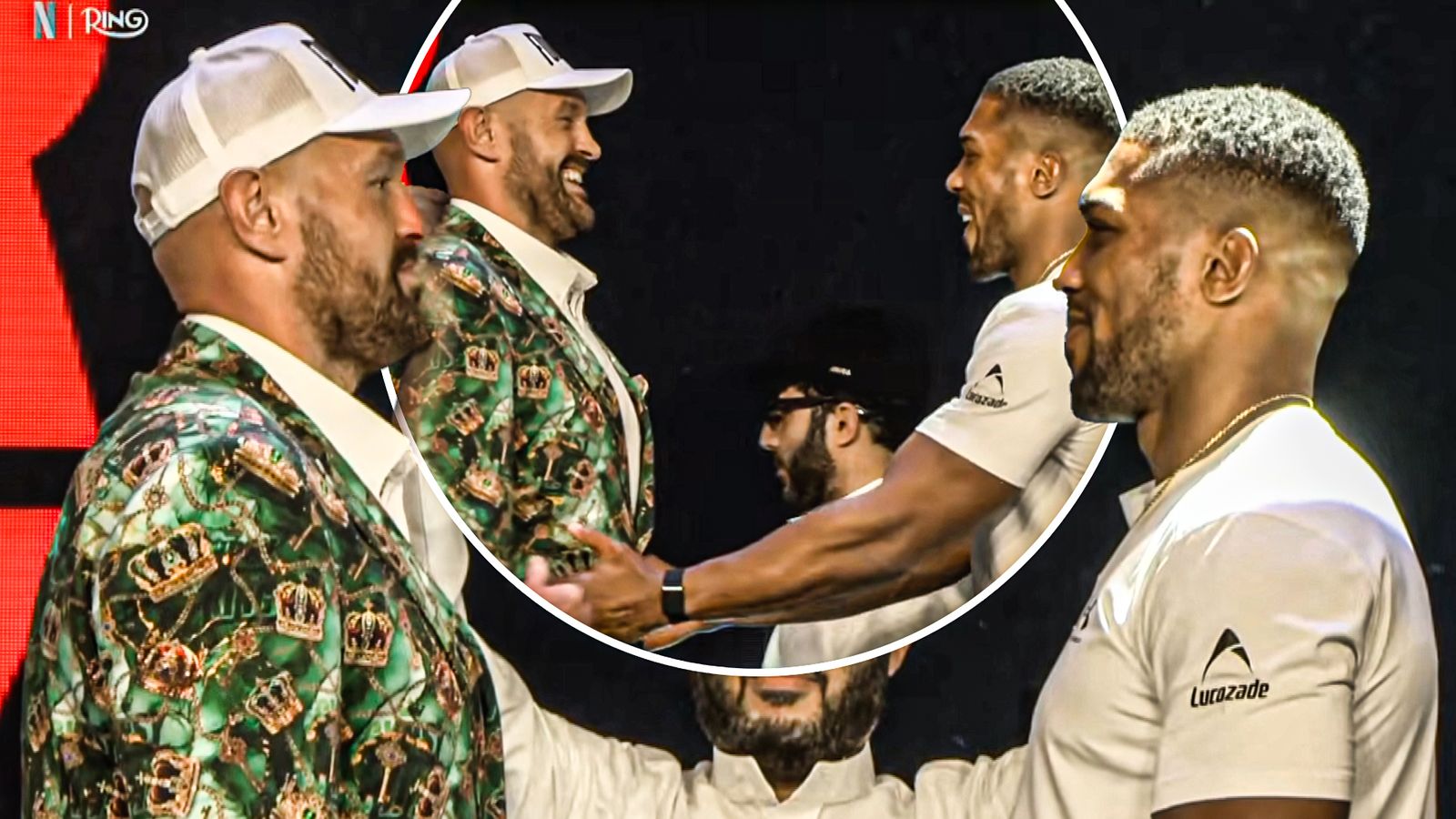 A man in a green patterned suit and white cap faces two men wearing white shirts onstage.