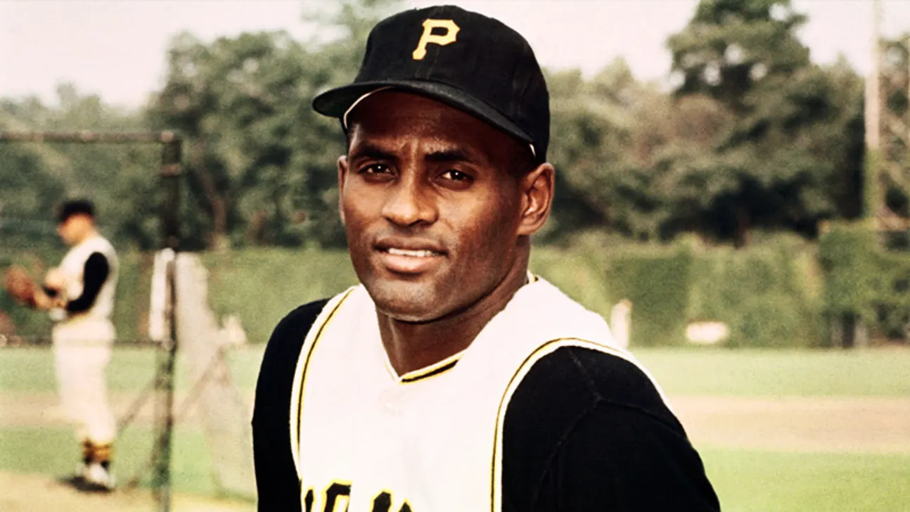 Baseball player in a Pittsburgh Pirates uniform and cap poses on a field.