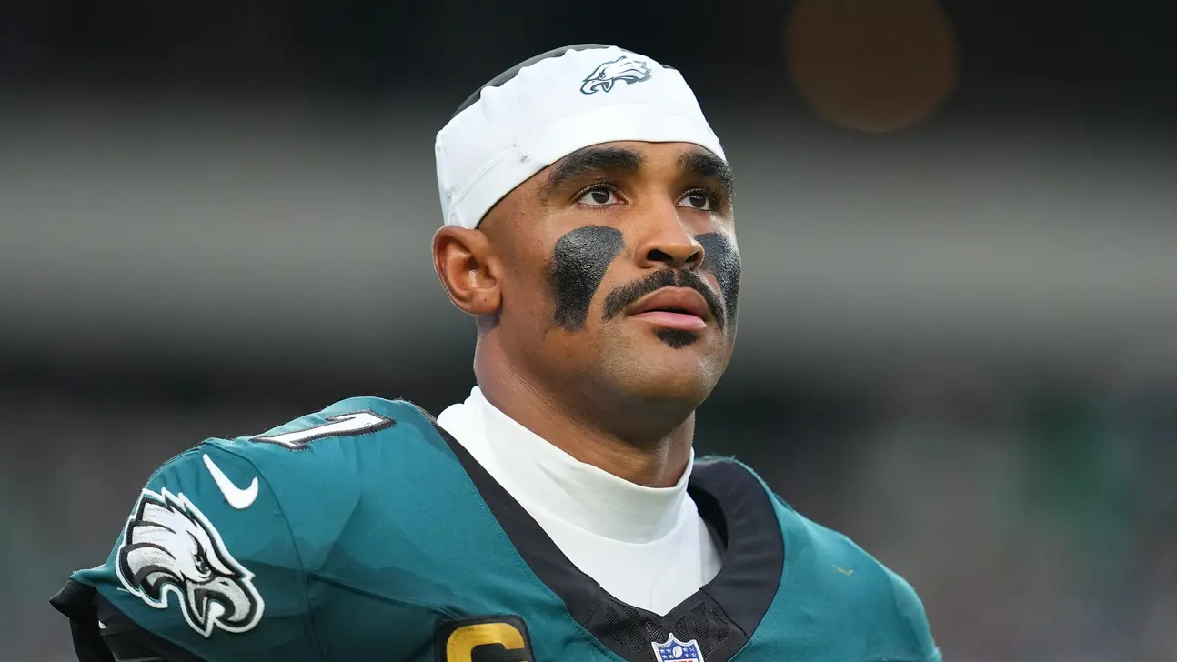 Philadelphia Eagles football player wearing a white head covering and teal uniform with black eye paint
