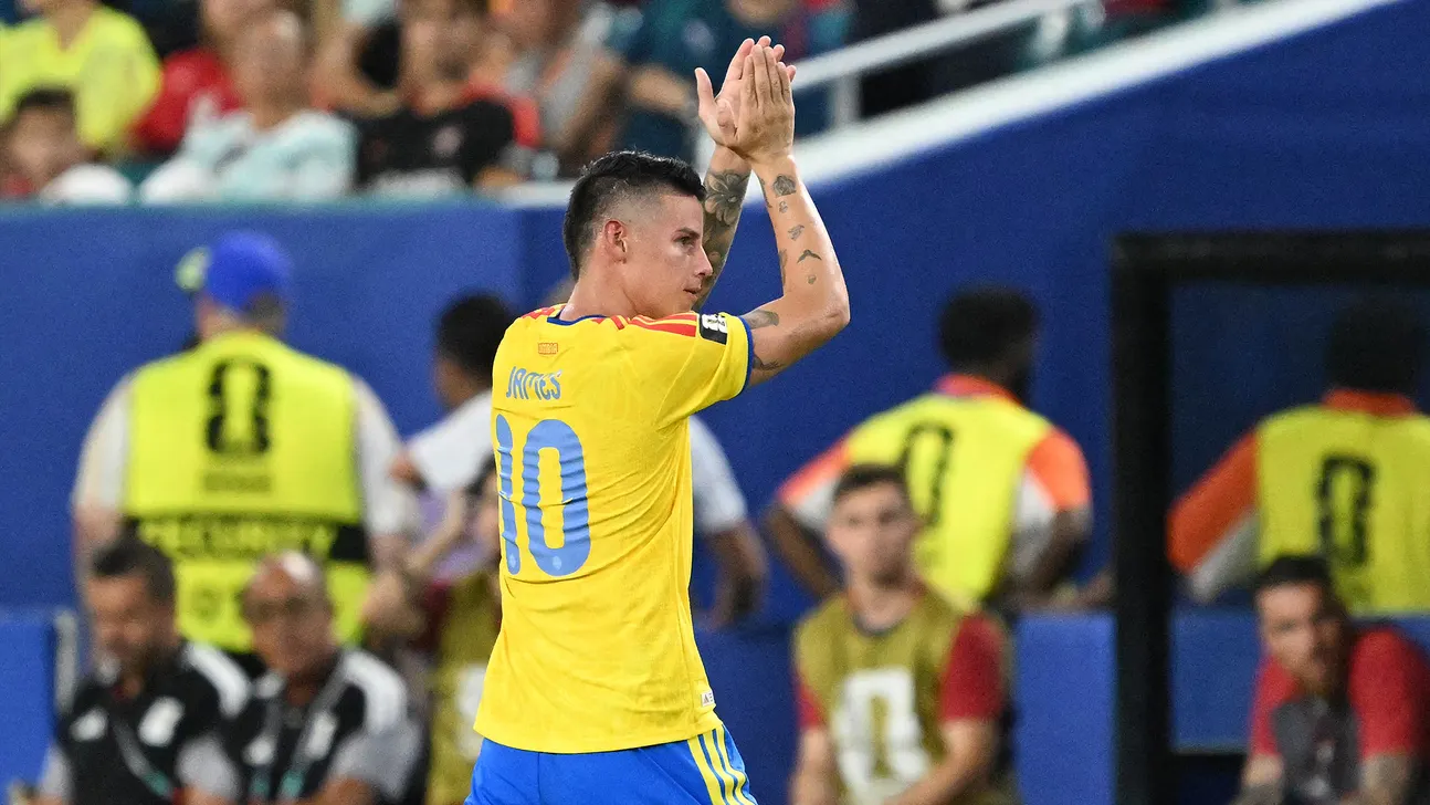 Colombian footballer wearing number 10 applauds supporters during a match.
