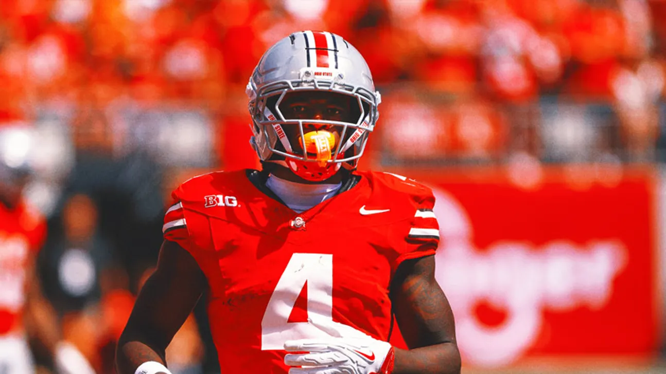 Ohio State football player wearing a silver helmet and red jersey with number 4