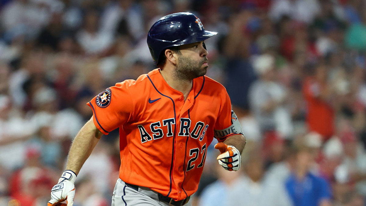 Houston Astros player in orange jersey and helmet running during a baseball game