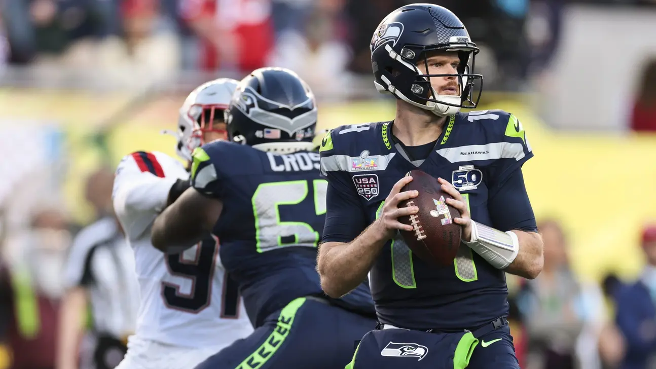 Seattle Seahawks quarterback holds a football during a game against the New England Patriots.