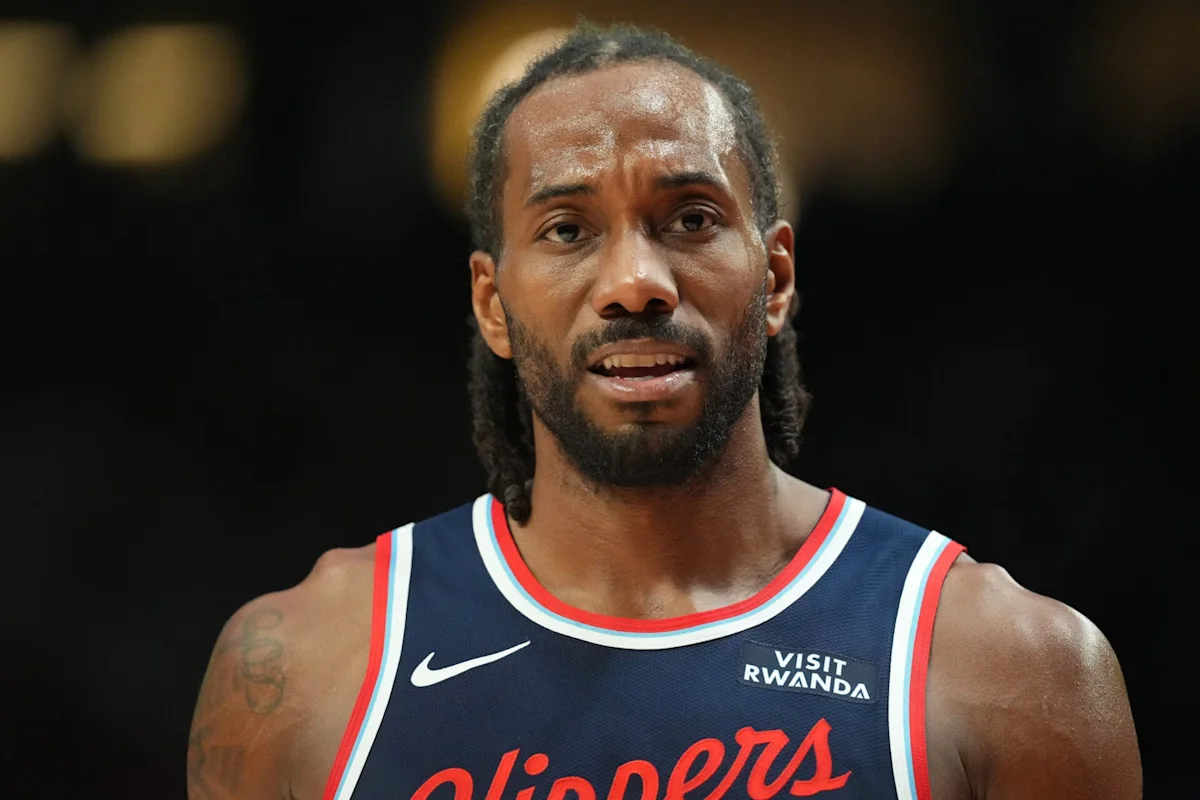 Basketball player with braided hair wearing a Clippers jersey during an interview or game