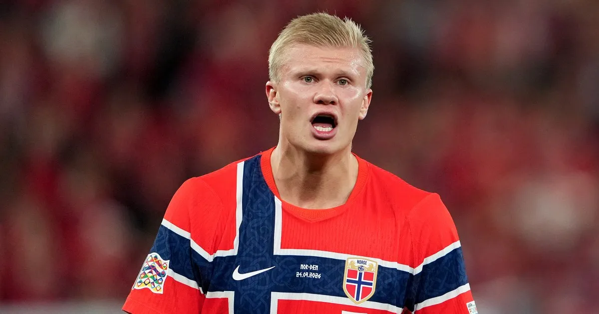 Blond footballer in Norway’s red, white and blue jersey shown against a blurred stadium crowd.