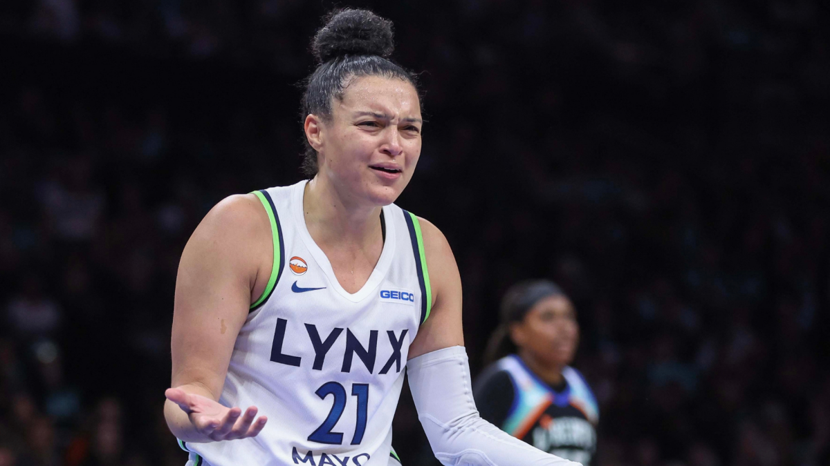 Minnesota Lynx player in a white No. 21 jersey gestures with an open hand during a game.