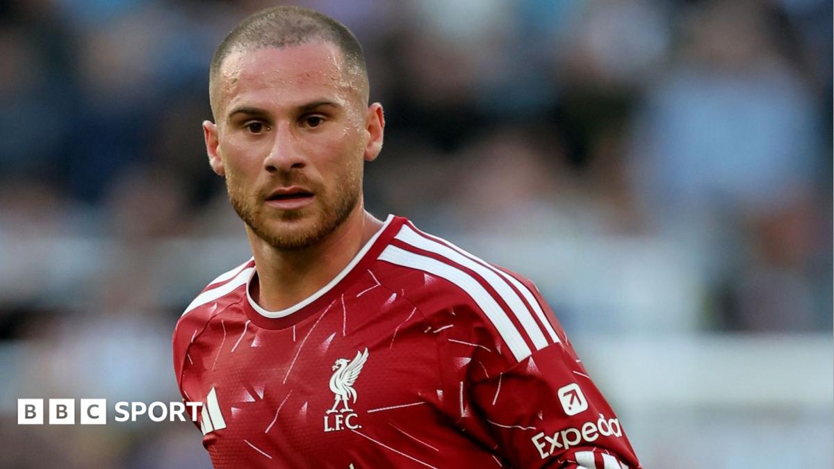 Liverpool footballer in red Adidas jersey looking ahead during a match