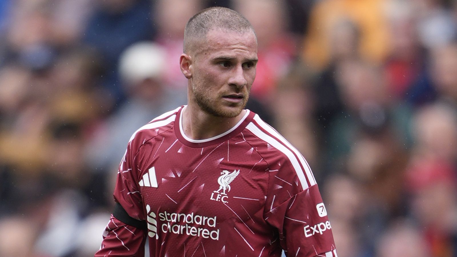 Liverpool footballer in a red jersey looks on during a match