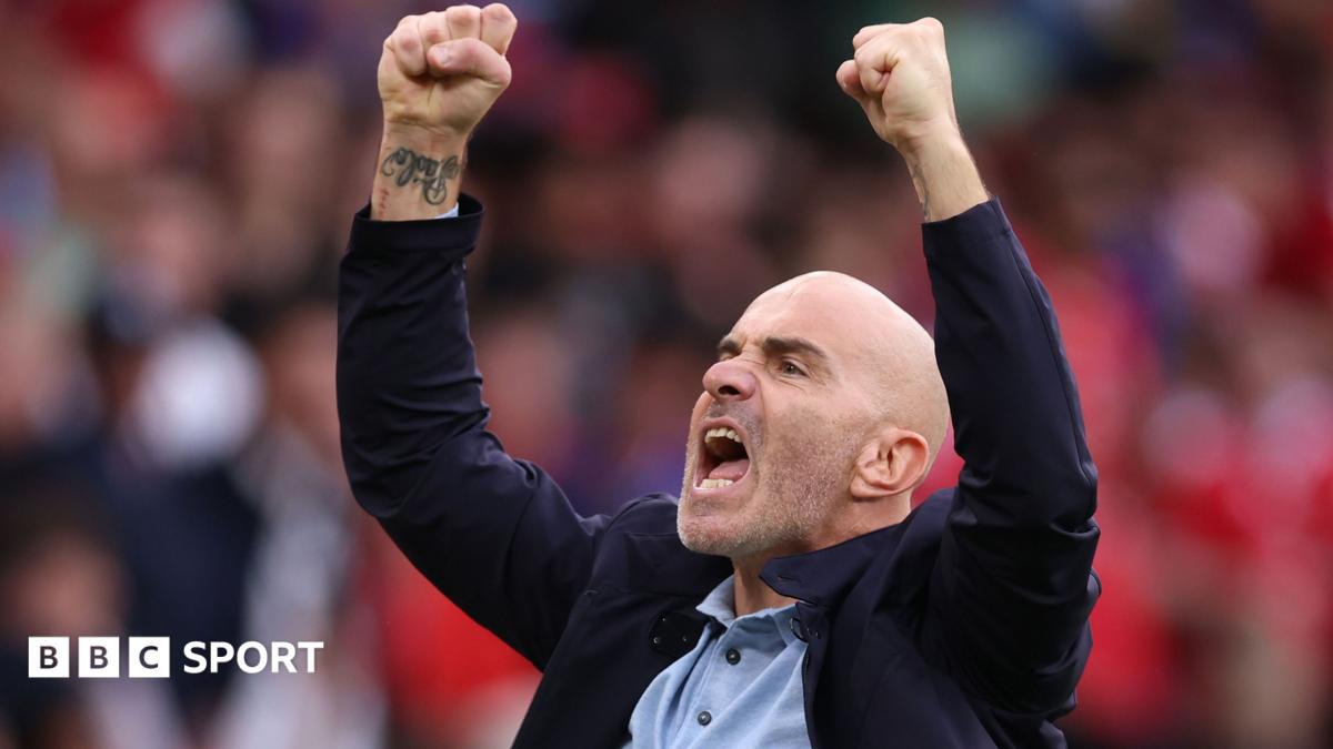 Bald man in dark jacket raises both fists and shouts in celebration