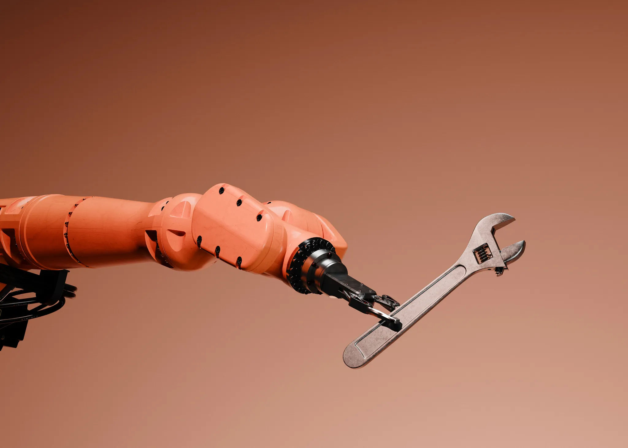 Orange robotic arm holding an adjustable wrench against a terracotta background