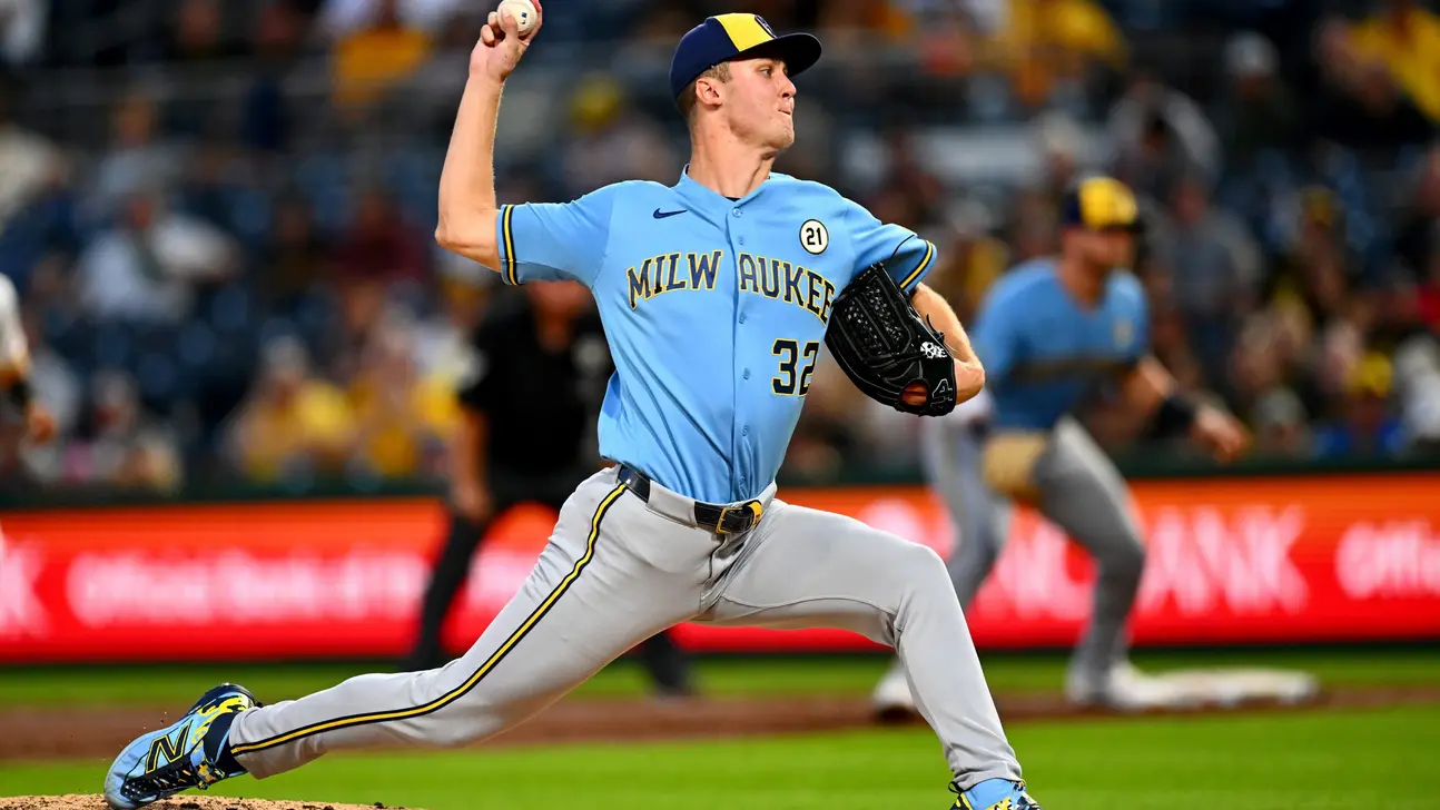 Milwaukee Brewers pitcher in blue uniform delivers a pitch during a baseball game
