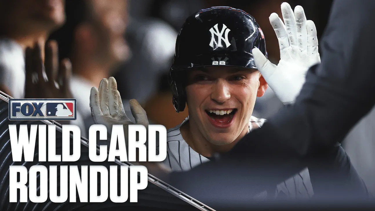 Smiling Yankees player in a batting helmet raises gloved hands as a Fox Wild Card Roundup graphic appears.