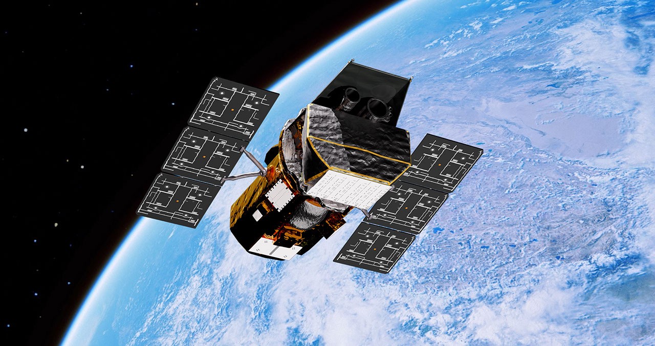 Illustration of a spacecraft with four solar panels orbiting above Earth, with space in the background.