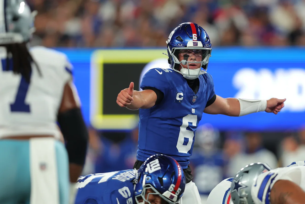 New York Giants quarterback gestures at the line of scrimmage during an NFL game