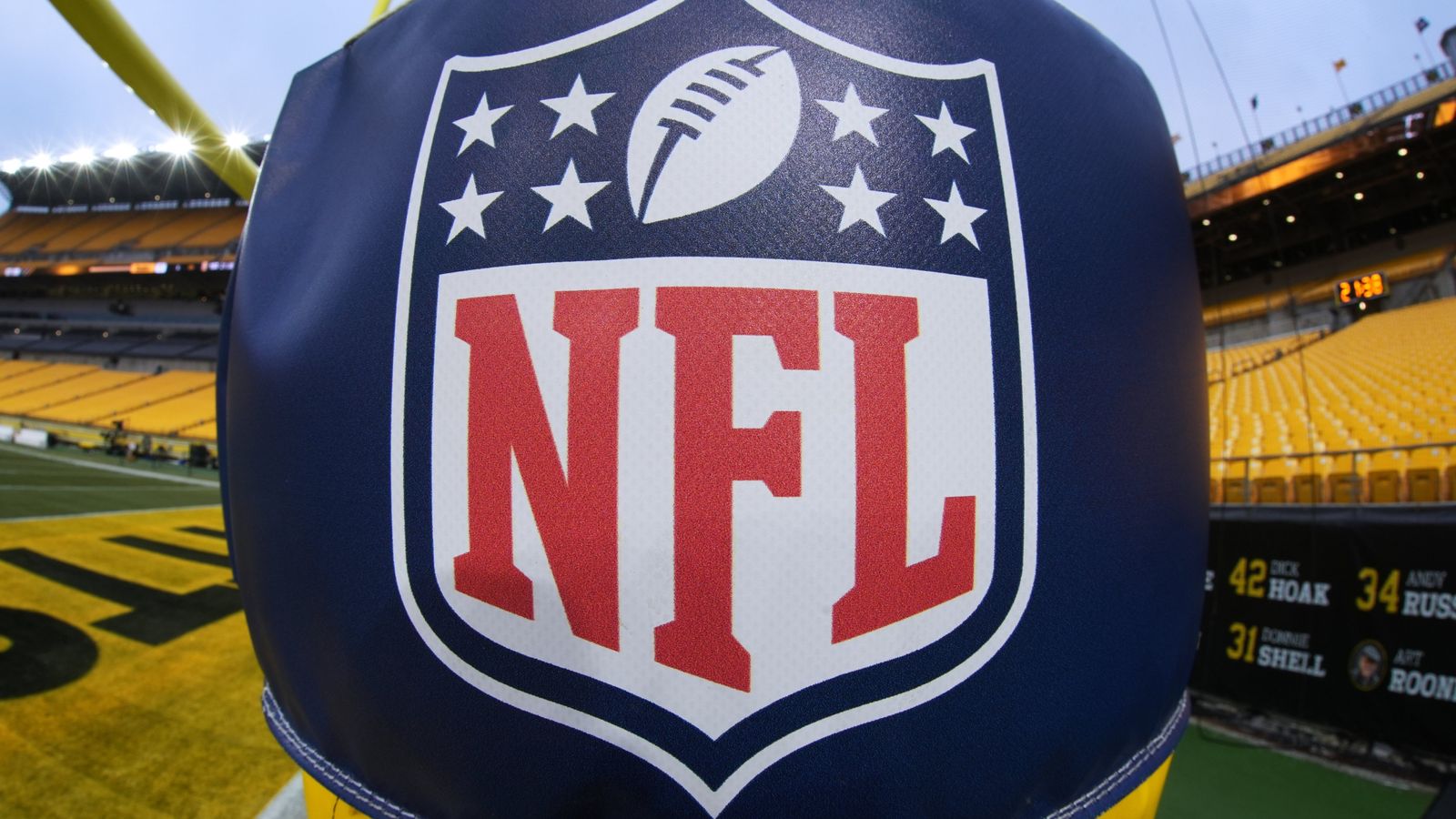 Close-up of an NFL logo on a football helmet inside a stadium.