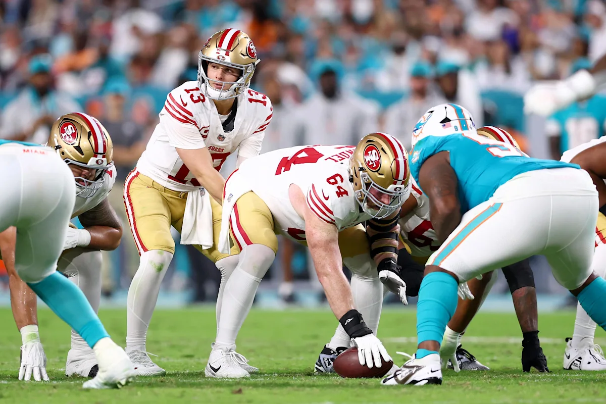 San Francisco 49ers quarterback prepares to snap the football against Miami Dolphins defenders