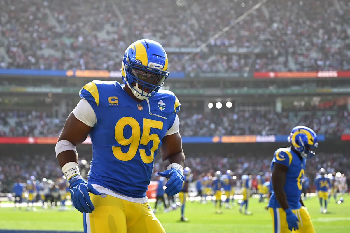 Los Angeles Rams player wearing number 95 runs on the field during a game.