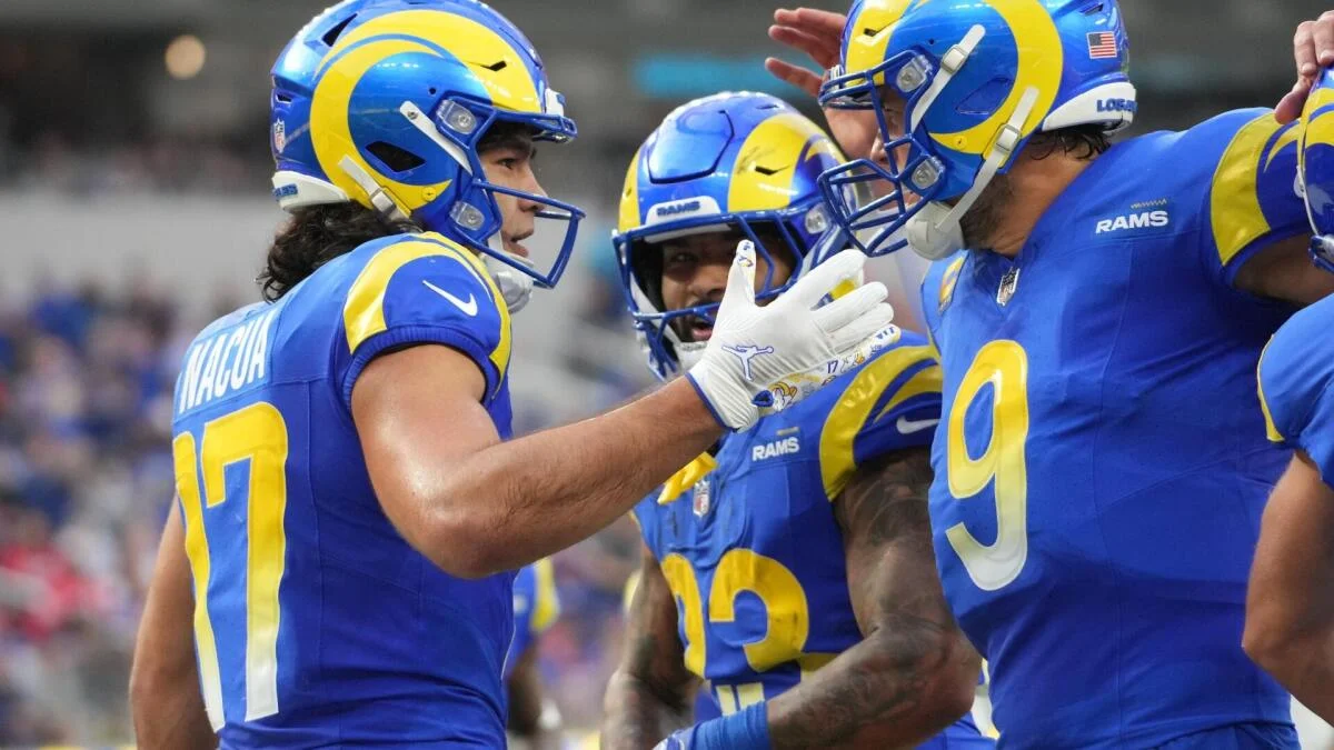 Los Angeles Rams players in blue and yellow uniforms gather together during a football game.