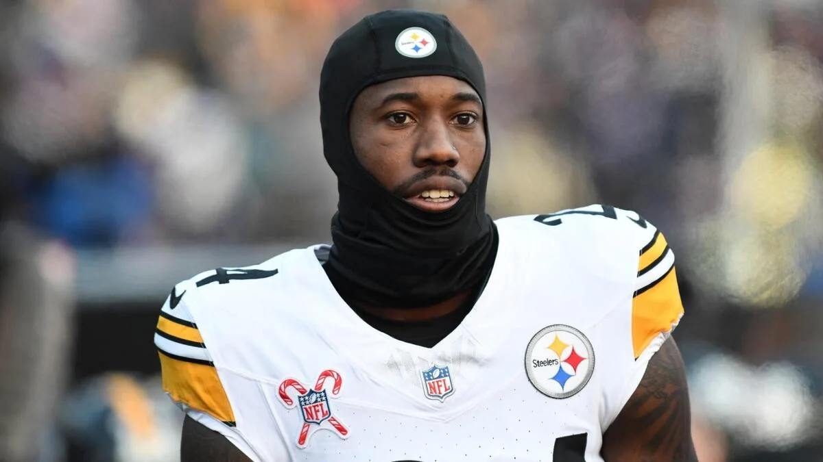 Pittsburgh Steelers player wearing a black skullcap and white uniform on the football field