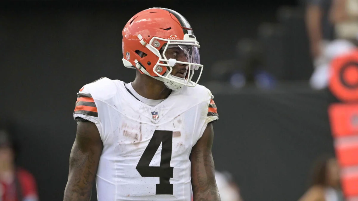 Cleveland Browns player wearing helmet and white number 4 jersey during a football game