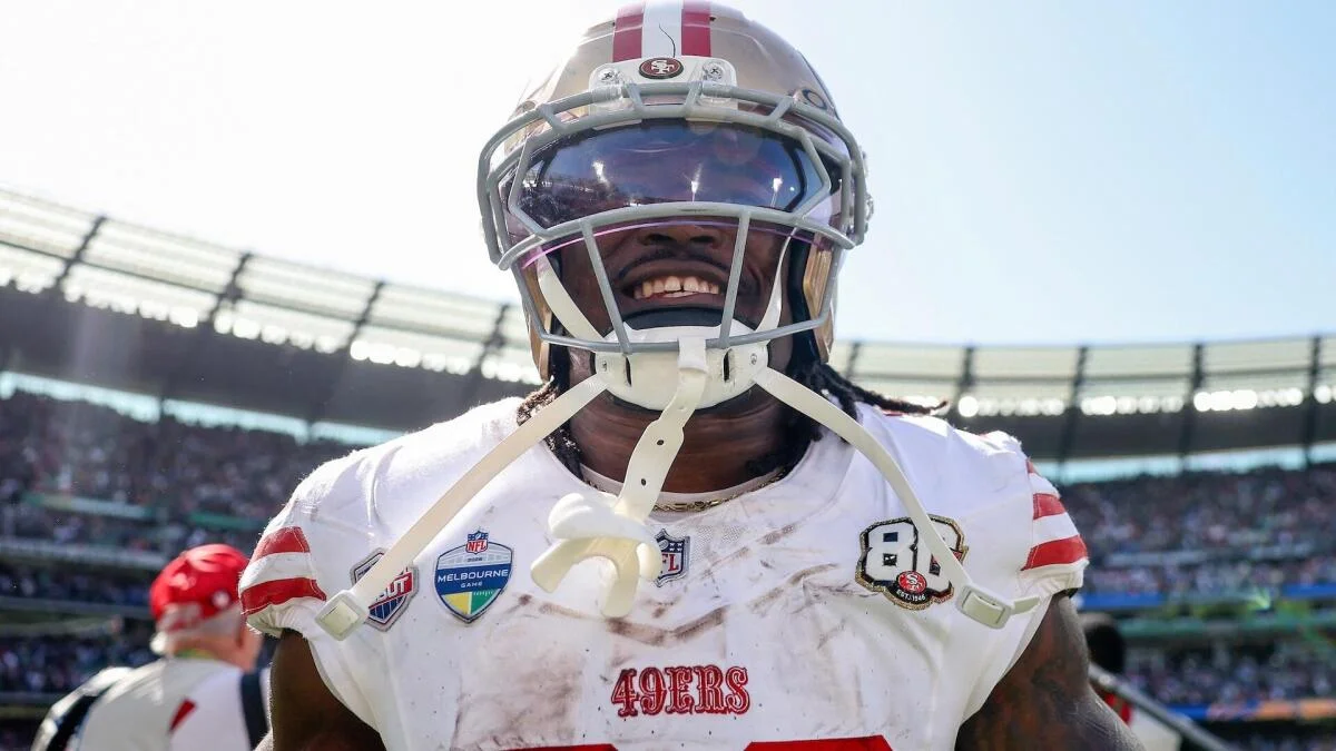 San Francisco 49ers football player wearing number 8 smiles in uniform on the field