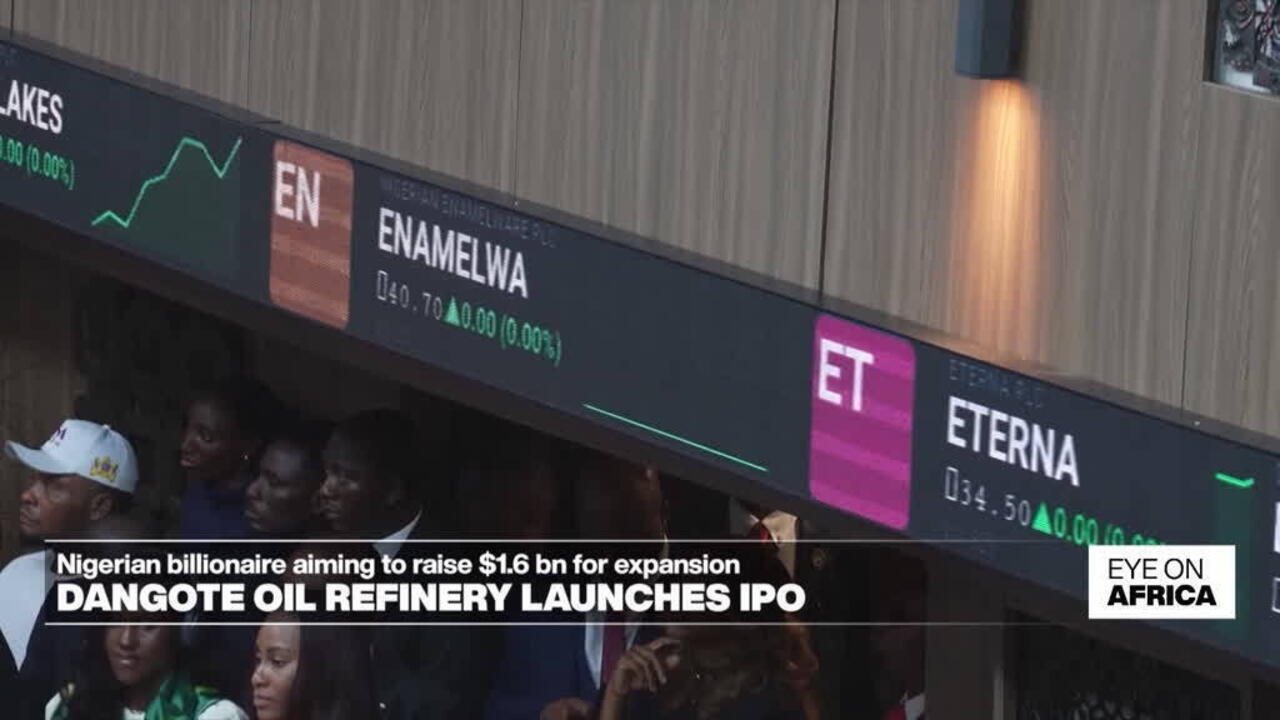 Stock exchange display showing Enamel WA and Eterna listings above a crowd at a market event