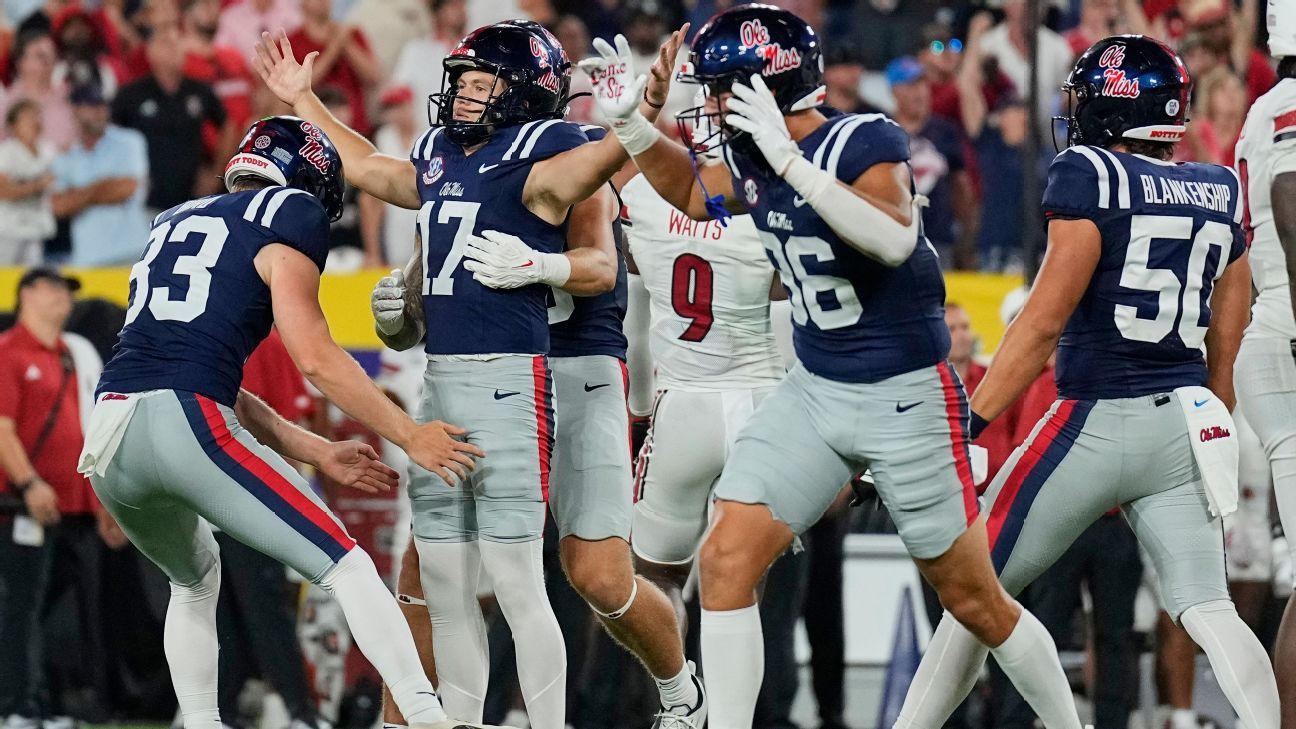 Ole Miss football players celebrate during a game against Louisville.