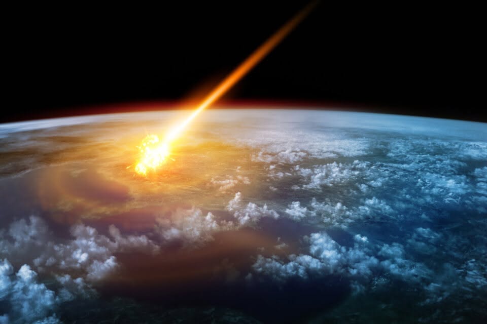 Bright meteor-like object streaking toward Earth’s cloud-covered atmosphere with a fiery impact glow