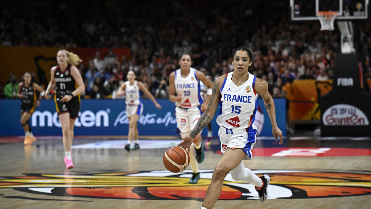 French women's basketball player dribbles toward the basket during an international game.