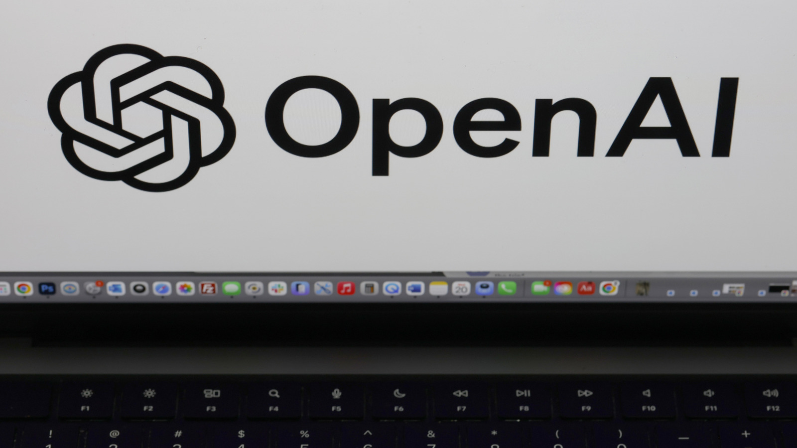 OpenAI logo displayed prominently on a laptop screen above the keyboard