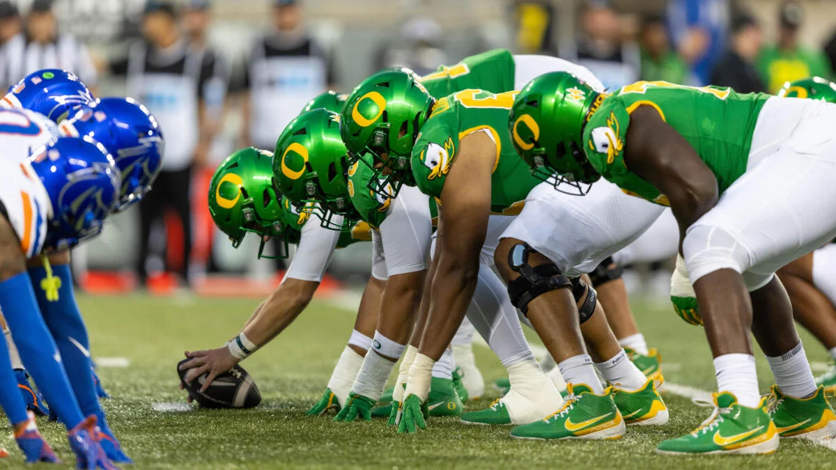 Oregon players line up against Boise State players before a football snap