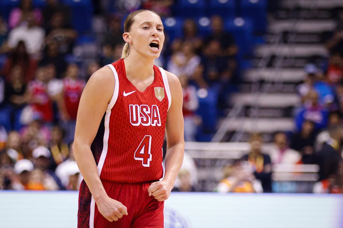 Basketball player in red USA jersey celebrates during an international game.