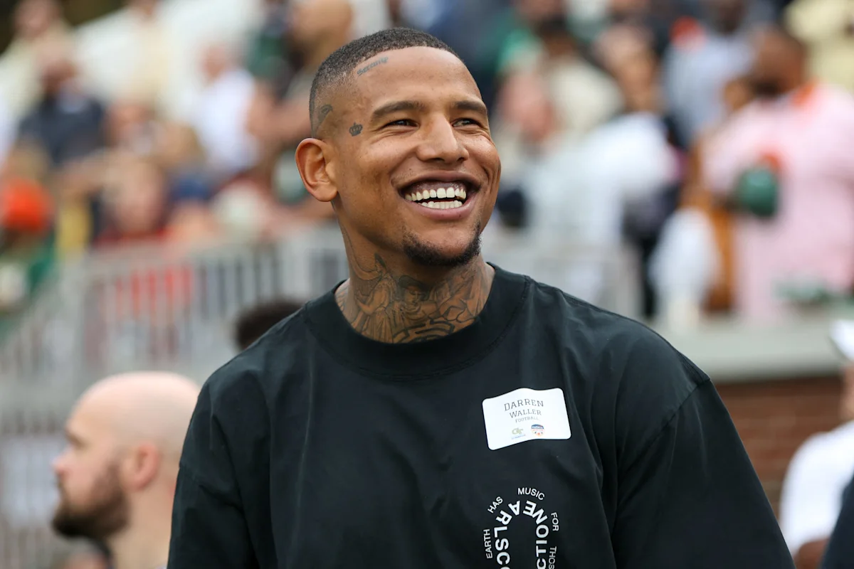 Smiling football player Darren Waller wearing a black shirt at a public event