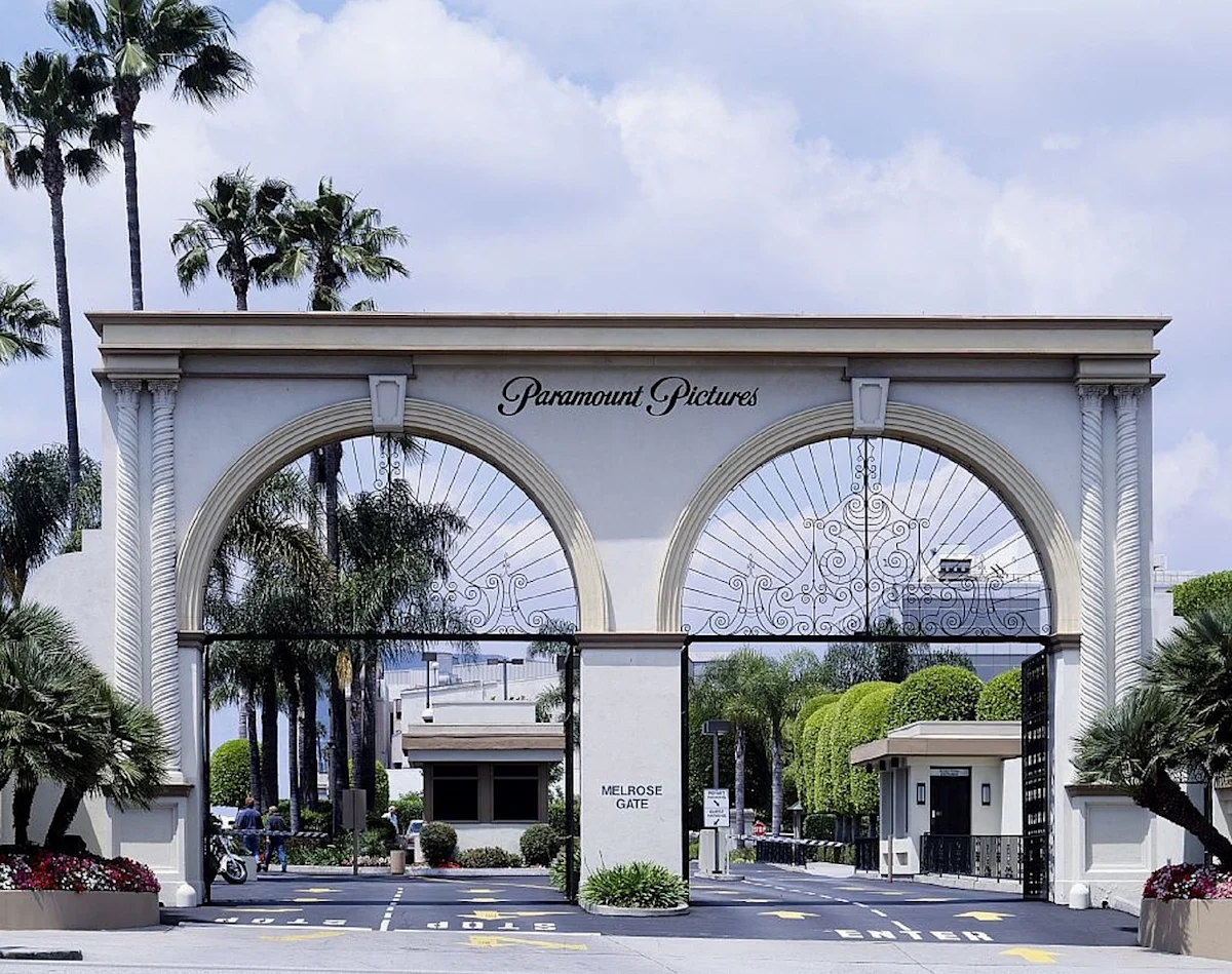 Paramount Pictures gate with arched entryways, palm trees, security booths and Melrose Gate sign